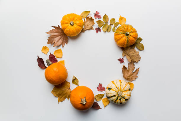 istock Autumn composition Pumpkins with fall leaves over coloredbackground. Top view with copy space 1407496702