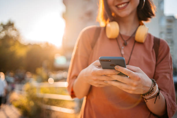 istock Young Woman Using Phone Outdoors 1407497657