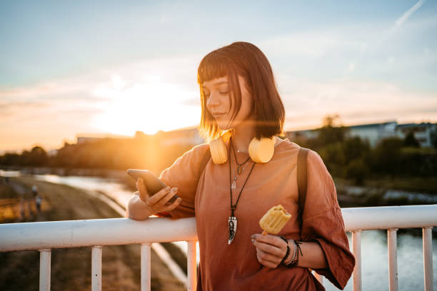 istock Young Woman Using Phone On The Bridge 1407497698