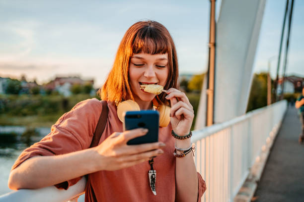 istock Young Woman Using Phone On The Bridge 1407497712