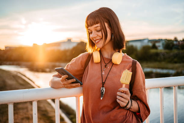 istock Young Woman Using Phone On The Bridge 1407497743