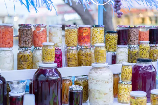 Photo of Various jars of pickles sold on the street
