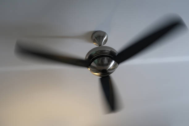Blurred rotating hotel room ceiling fan from below.  Metaphor for hot climate, heatwave and cooling air.  Maspalomas, Grand canary, Canary Islands, Spain, July 4, 2022