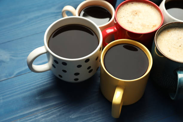 istock Many cups of different coffee drinks on blue wooden table 1407501369