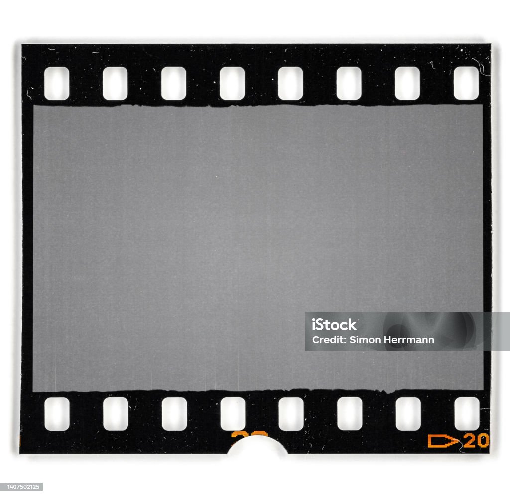 single 35mm film snip with black border and empty frame. 35mm filmstrip. Film Reel Stock Photo