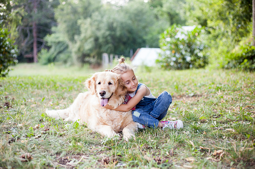 little girl with her dog having fun outdoor