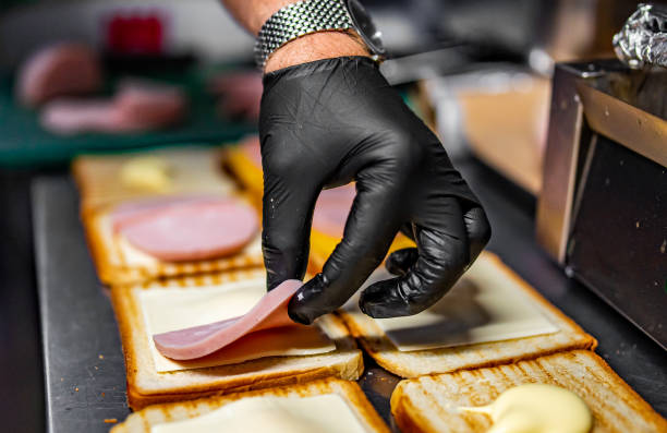 istock chef hand cooking sandwich with meat and vegetables on kitchen 1407506211