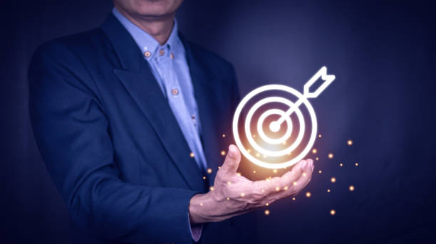 istock Businessman holding virtual dartboard and arrow with copy space for setup business objective target concept. 1407509782