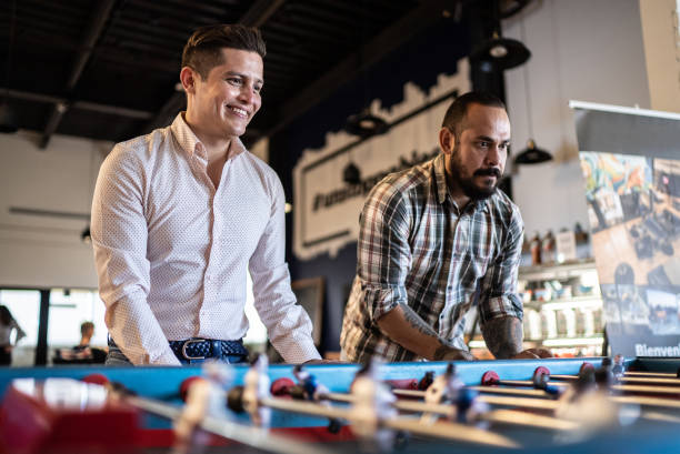 istock Coworkers having a friendly match on a foosball table 1407509960