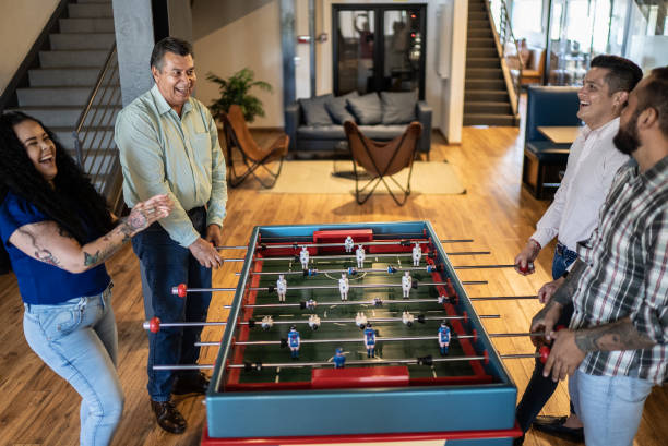 istock Coworkers having fun at the foosball table 1407510413