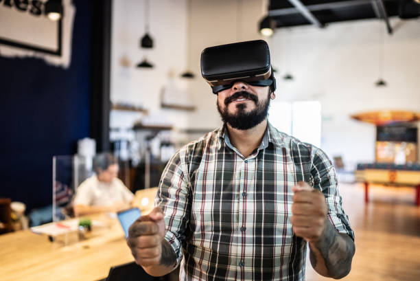 Mid adult man using a virtual reality glasses in the office