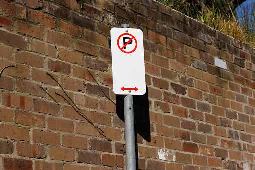 White metal No Parking sign.