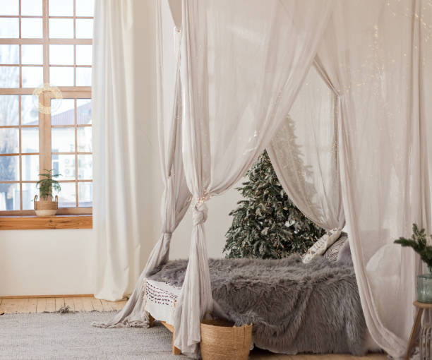 istock Christmas scandinavian bedroom with white canopy 1407511321