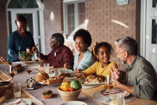 istock Happy multiethnic family enjoying while having a meal at dining table on patio. 1407511463