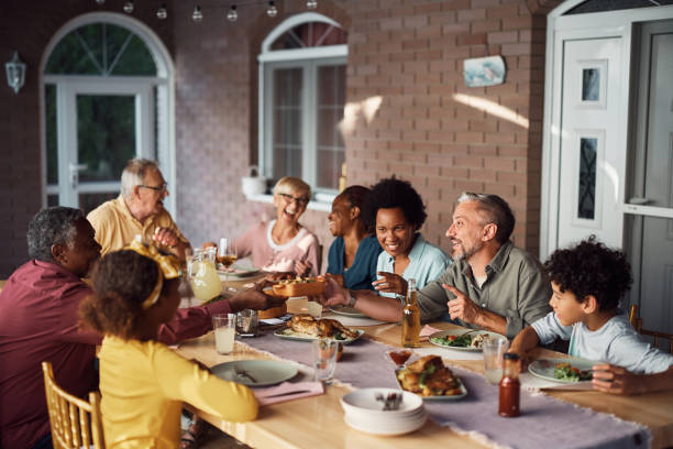 istock Happy multiethnic extended family eating at dining table on a patio. 1407512016