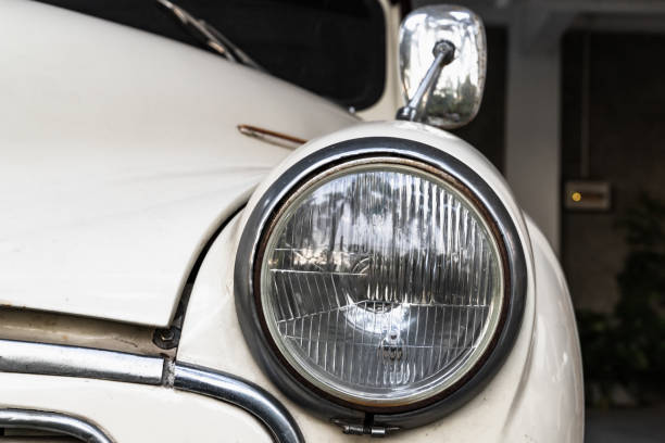 istock Round headlight of a white old timer car. Close up 1407513591