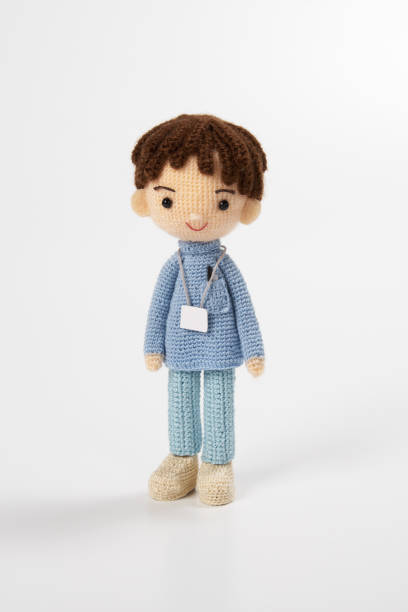 istock Small and cute Amigurumi doll on white background.　nursing 1407516159