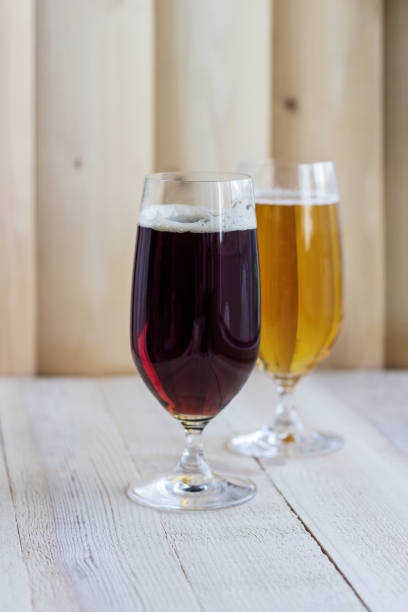 istock Two glasses of beer on wood background with copyspace 1407517721