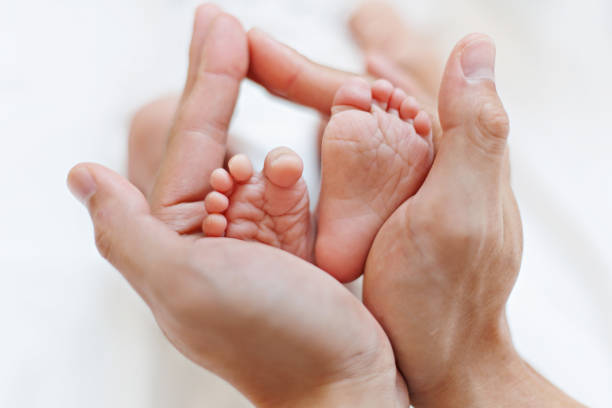 istock Newborn baby feet 1407518771