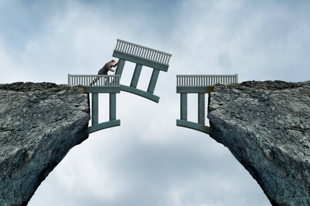 istock Man Pushes Missing Piece Of Bridge Into Place 1407521497