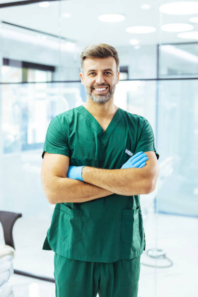 istock Dentist smiling in exam room 1407522229