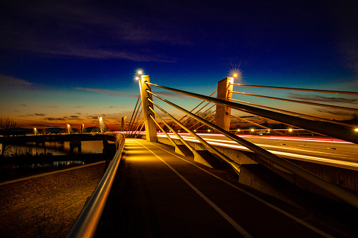 Illuminated light trails on Puch bridge over Drava river in Ptuj against sky during dusk