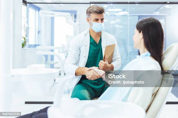Woman Shaking Her Dentists Hand Stock Photo - Download Image Now - Doctor, Office, Protective Face Mask