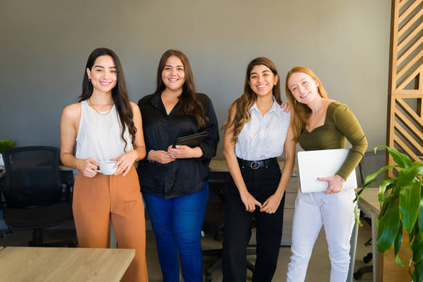 istock Attractive smiling young women working as a team 1407524711