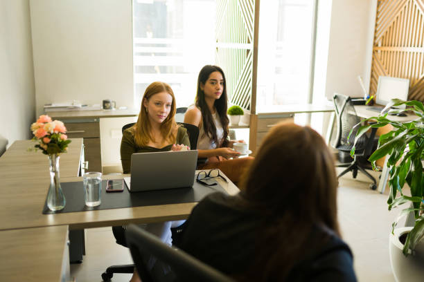istock Female workers at their desks in an all women workplace 1407524742