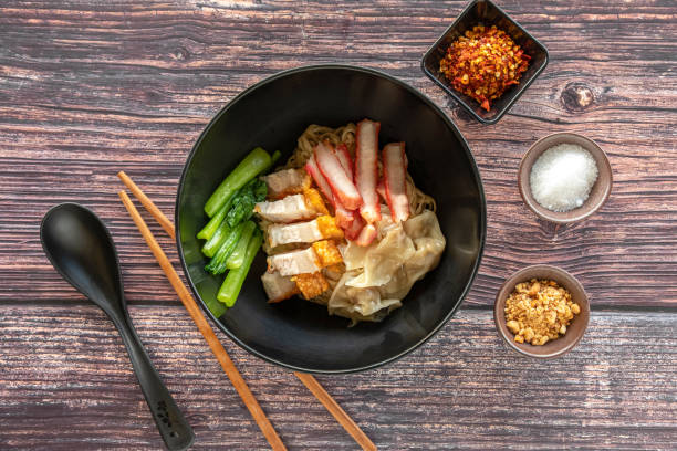 istock Top View of Pork Wonton Dumpling and Egg Noodle Soup with Vegetables 1407526154