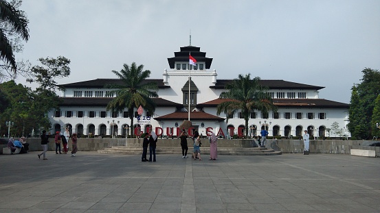 Bandung, Indonesia - June 25, 2022: Visitors take pictures in front of the Governor's building in West Java Indonesia.