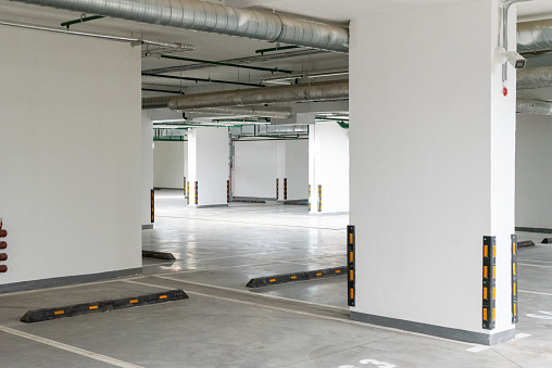 Empty underground parking of a residential building with parking restrictions and video surveillance. New house.