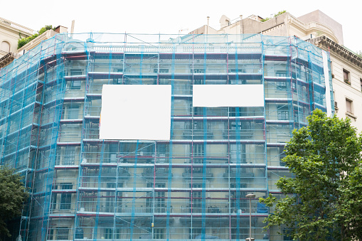 A building facade covered with a scaffolding