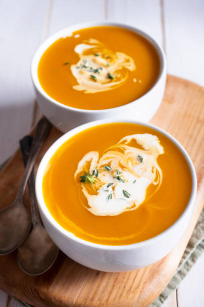 Butternut Squash Soup Creamy Butternut Squash Soup in Two Bowls squash soup stock pictures, royalty-free photos & images