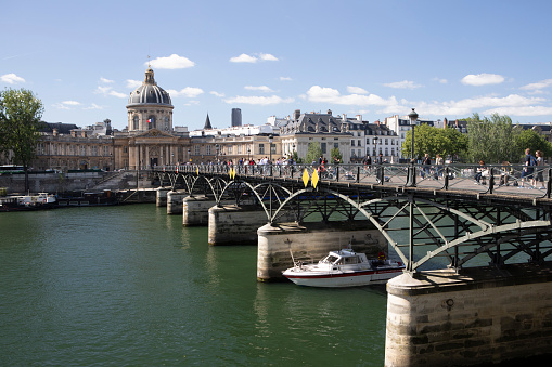 The Pont des Arts is a pedestrian bridge in Paris which crosses the River Seine, linking the Institut de France and the central square of the Palais du Louvre