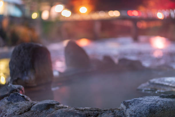 Night view of the open-air bath of the secret hot spring Nagayu Onsen An open-air bath called crab hot water at night when the warm steam of Nagayu Onsen in Oita Prefecture rises taketa photos stock pictures, royalty-free photos & images