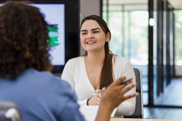 istock Young adult female smiles while she is being interviewed 1407536867