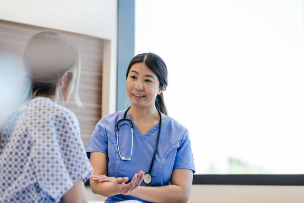 istock Female doctor gestures while explaining test results to hospital patient 1407537057