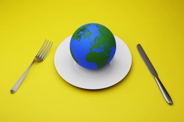 istock food crisis on the planet concept. globe on a plate and a fork with a knife. 3D render. 1407537940