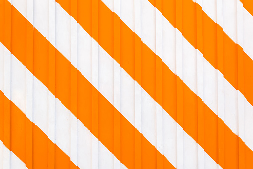 artistic orange striped background, slanted striped painted wall texture for summer or fall background.
