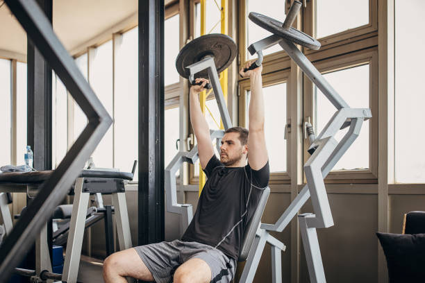 istock Man exercising in gym 1407538371