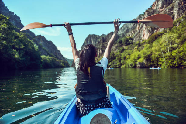 istock Happy Female Enjoying Cool Lake Breeze While Kayaking And Lifting Oar 1407539507