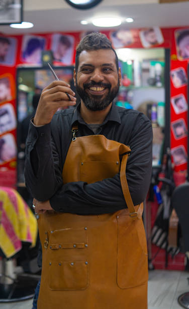Happy barber arab man portrait with scissors stock photo