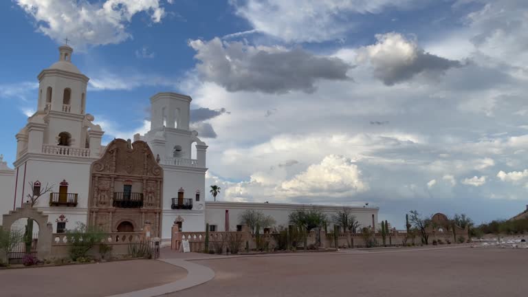 Beautiful vista of the San Xavier del Bac Mission in Tucson, Arizona, under dramatic monsoon sky