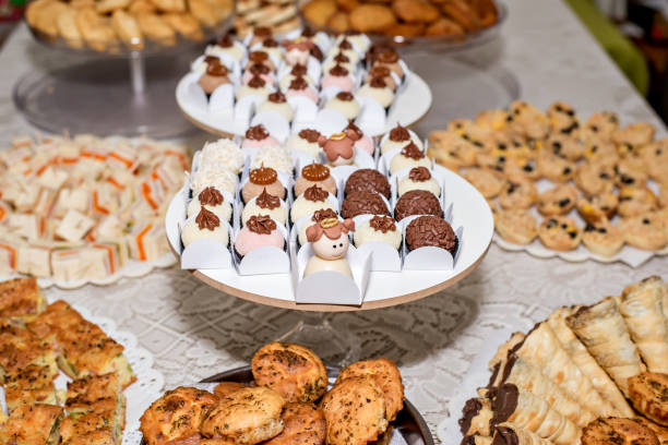 istock sweet and savory table at baptism celebration, angel chocolate candy. 1407548700