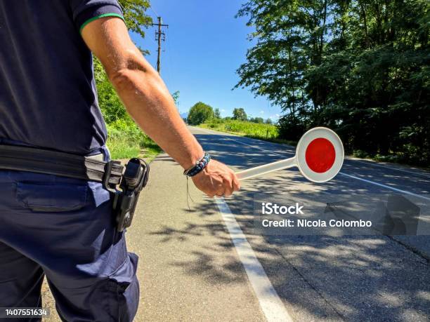 Policeman With A Paddle Closeup Stock Photo - Download Image Now - Police Force, Traffic Warden, Security Barrier