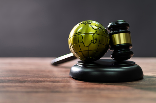 Gavel and globe on the table.
