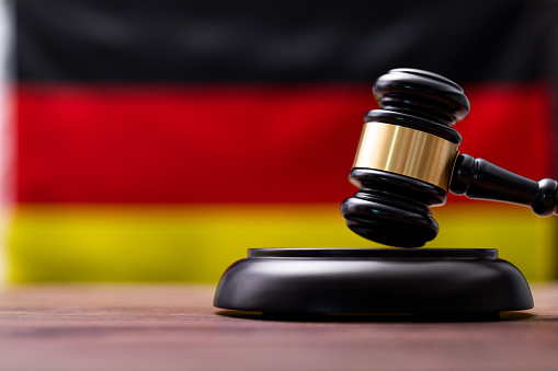 Wooden gavel and German flag.