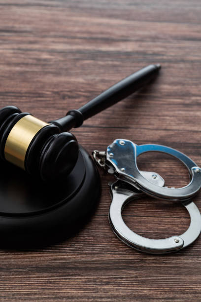 istock Gavel and handcuffs on wooden table 1407552435