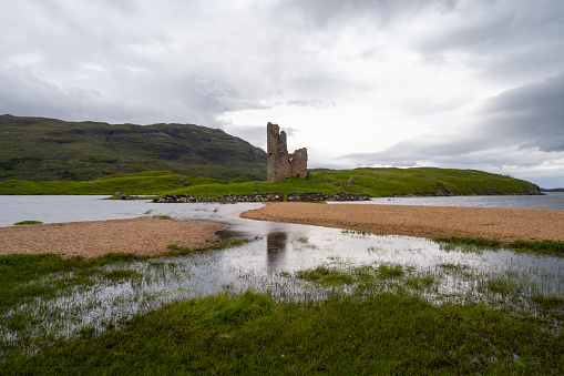 Inchnadamph, United Kingdom - 28 June, 2022: long exposure view of the Ardvreck Castle on Loch Assynt in the Scottish Highlands
